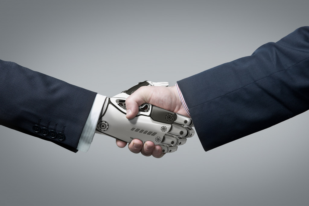 Business Human and Robot hands in handshake. Artificial intelligence technology Design Concept