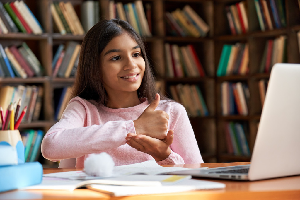 child doing sign language