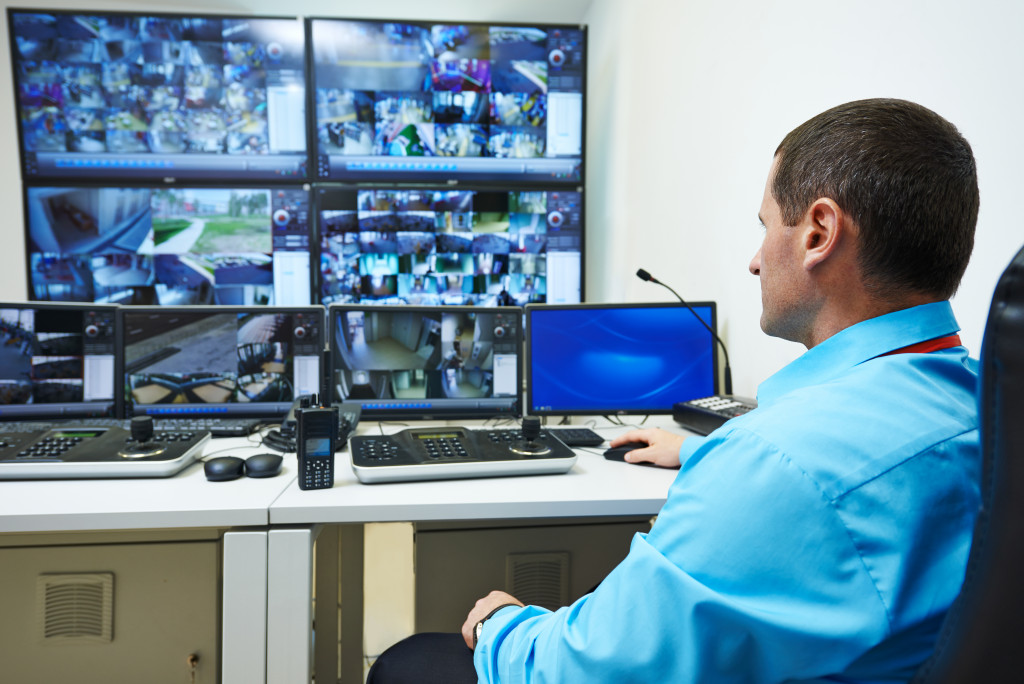 a man monitoring cctv cameras