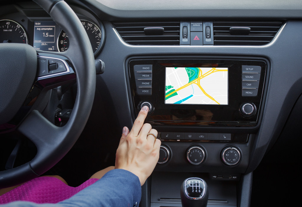 person interacting with the car's gps system