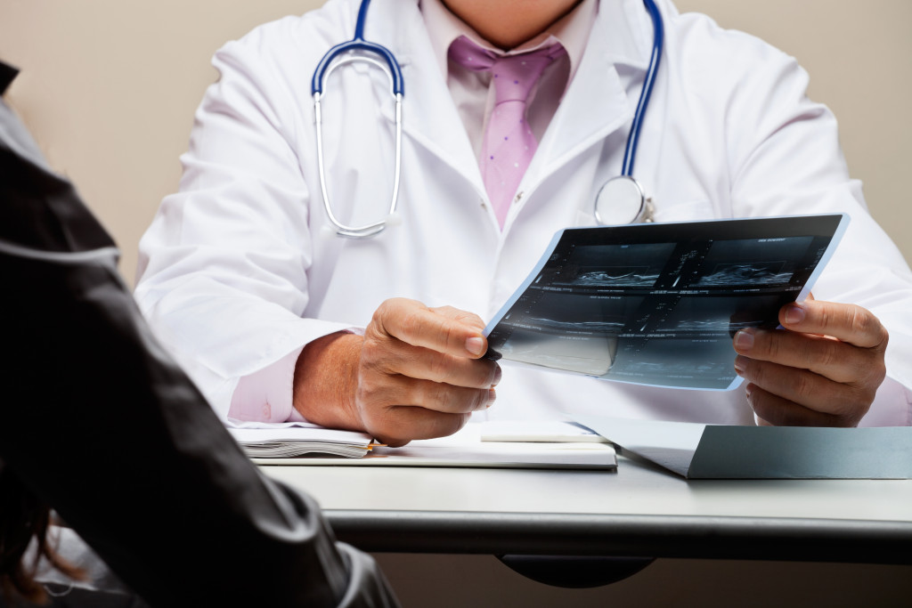 doctor examining xray of patient