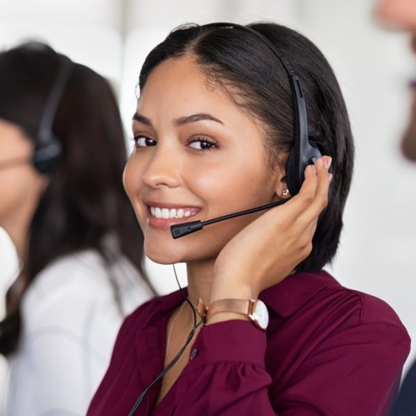 A call center agent looking at the camera while working