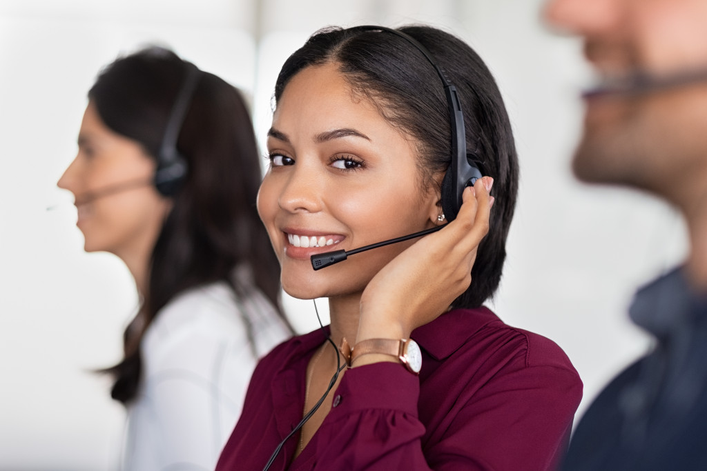 A call center agent looking at the camera while working