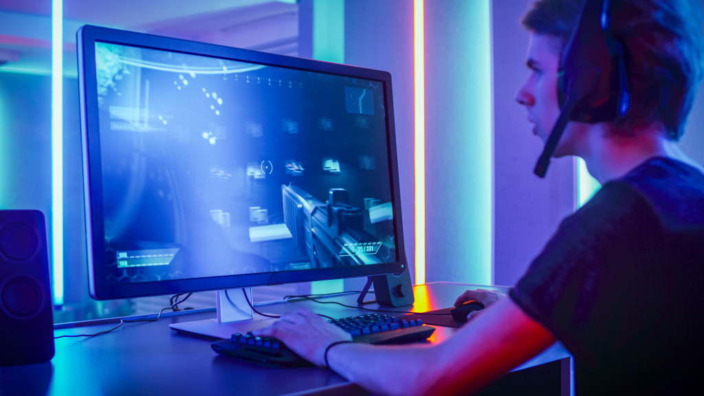 man playing FPS game in his gaming space